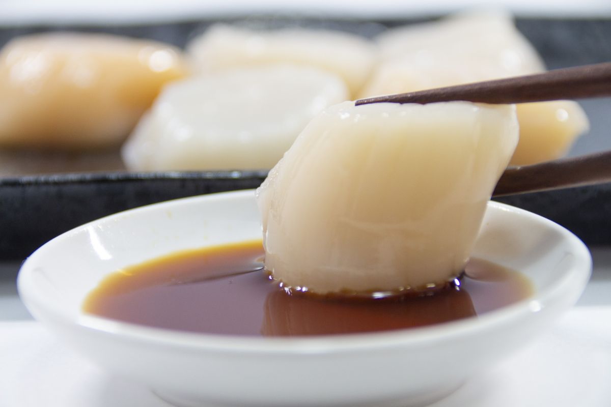 dipping-scallop-sashimi-into-soy-sauce