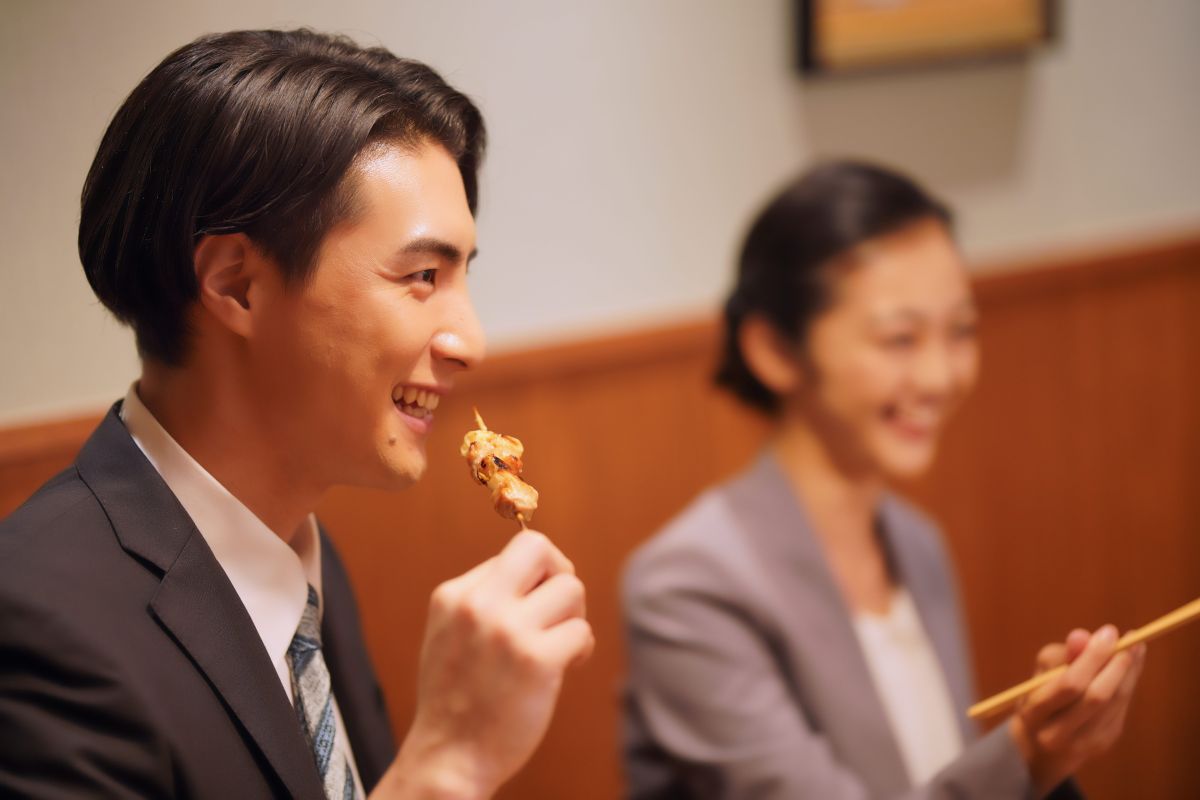 person-eating-yakitori